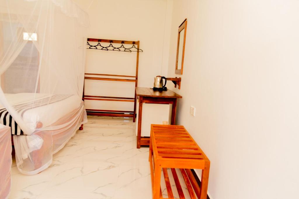 Postel nebo postele na pokoji v ubytování Samiru Guest Inn Ella