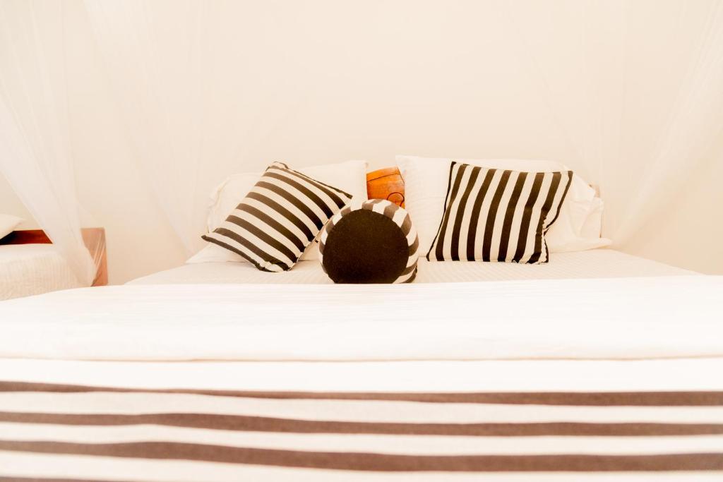Postel nebo postele na pokoji v ubytování Samiru Guest Inn Ella