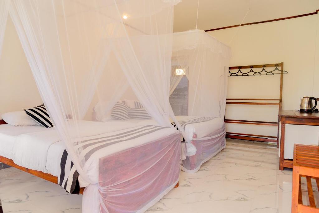 Postel nebo postele na pokoji v ubytování Samiru Guest Inn Ella