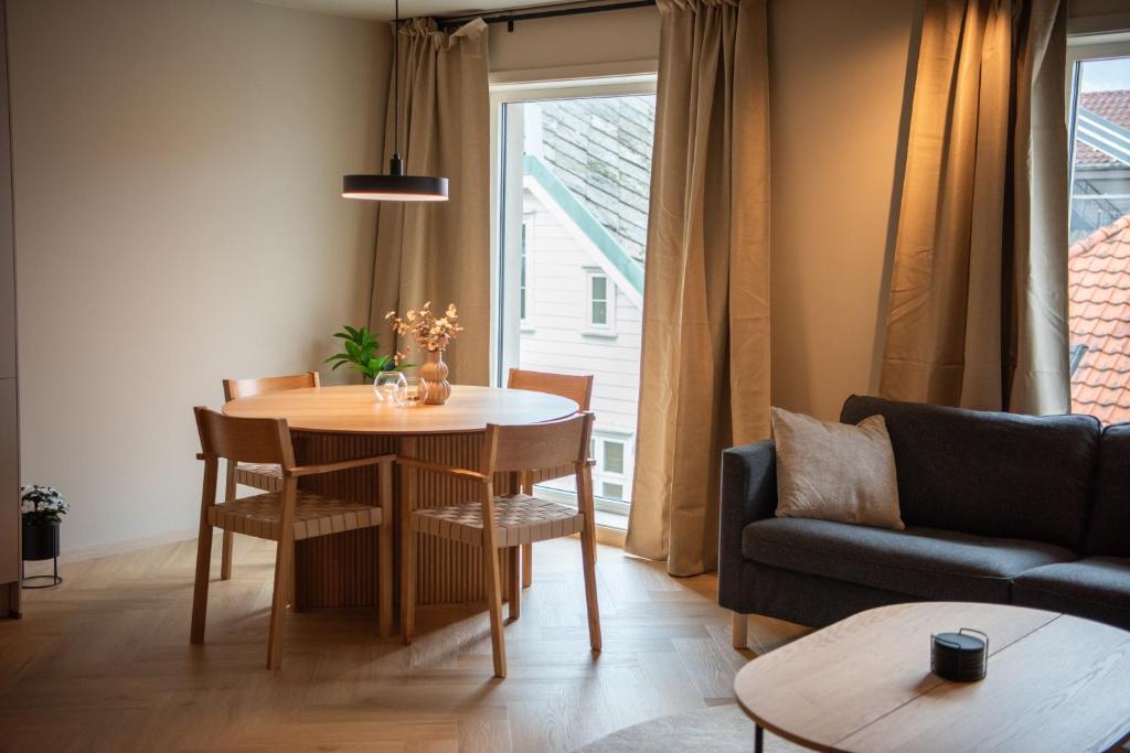 a living room with a table and a couch at Penthouse, heart of city center, high standard in Stavanger