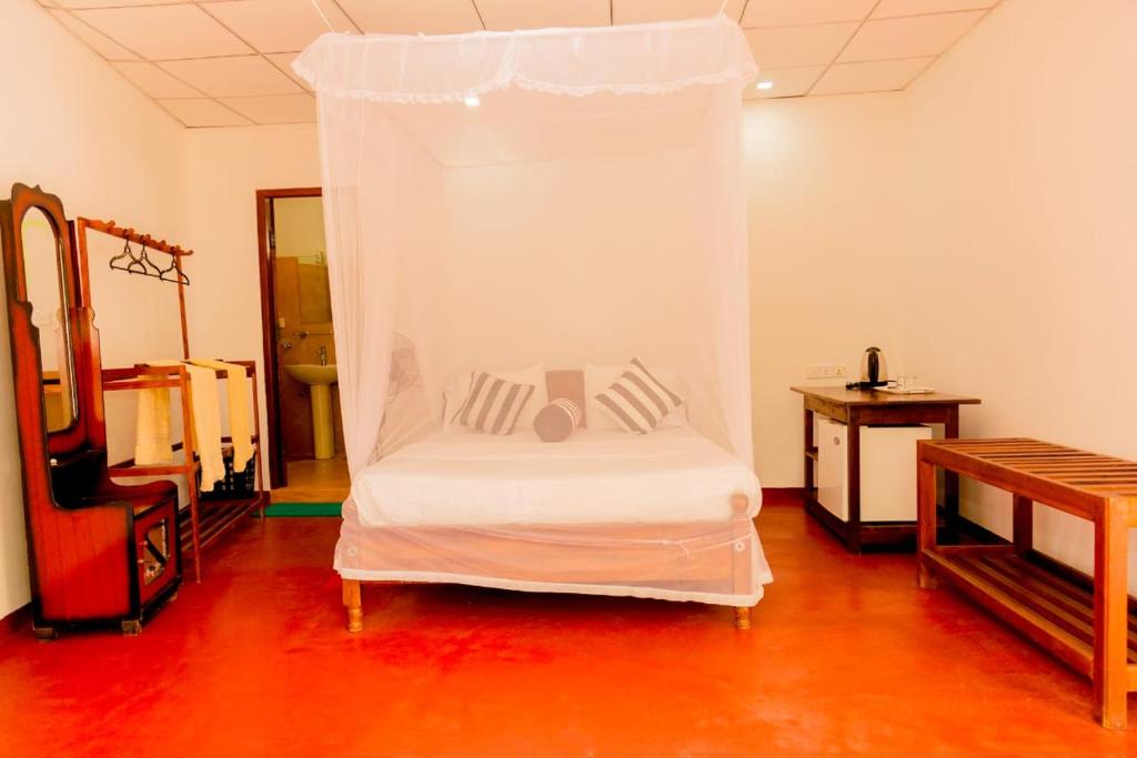 Postel nebo postele na pokoji v ubytování Samiru Guest Inn Ella