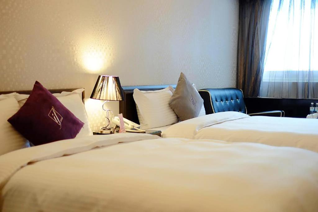 Postel nebo postele na pokoji v ubytování 意芙旅店 Ifinn Hotel