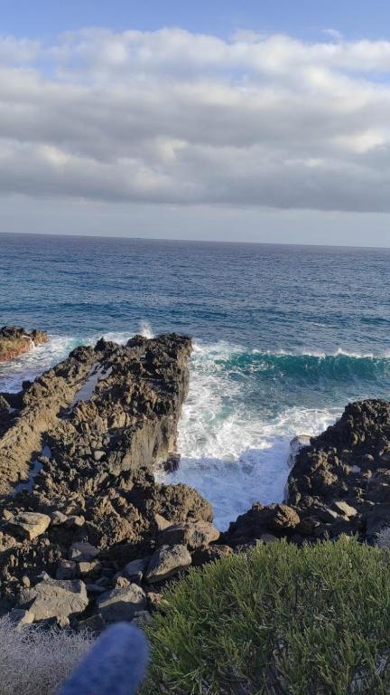 a view of the ocean from a rocky beach at La Ballena Azul in Los Silos