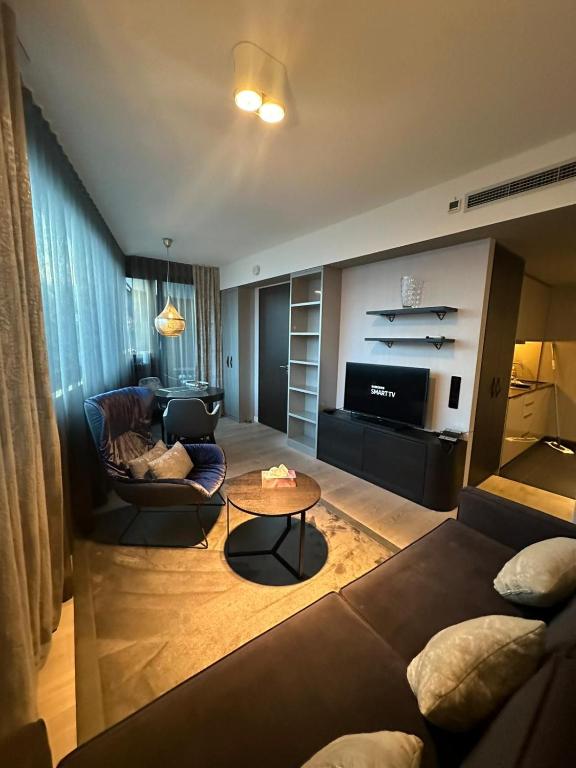 a living room with a couch and a table at Suites im Cloud in Stuttgart