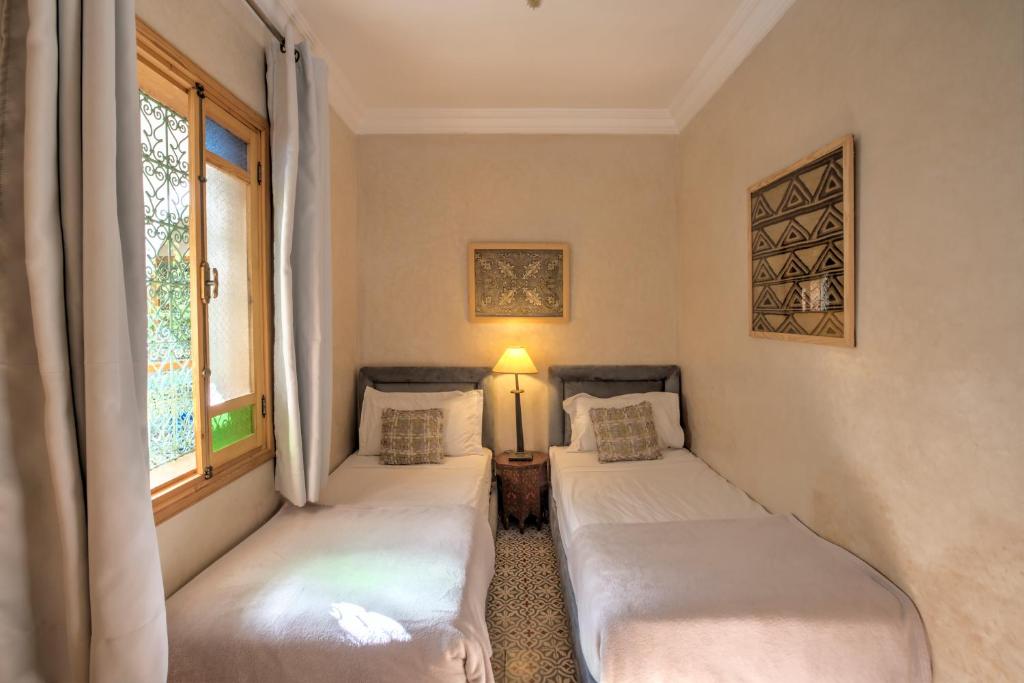 Postel nebo postele na pokoji v ubytování Riad Inaka