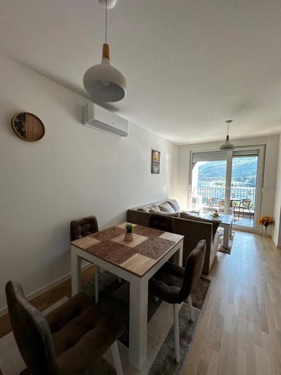 a living room with a table and chairs and a couch at Apartment Ivan in Mostar