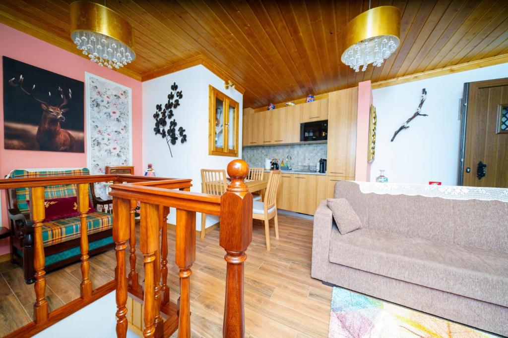 a living room with a couch and a kitchen at Montanhas do Xisto - Solar do Xisto Nascente in Candal