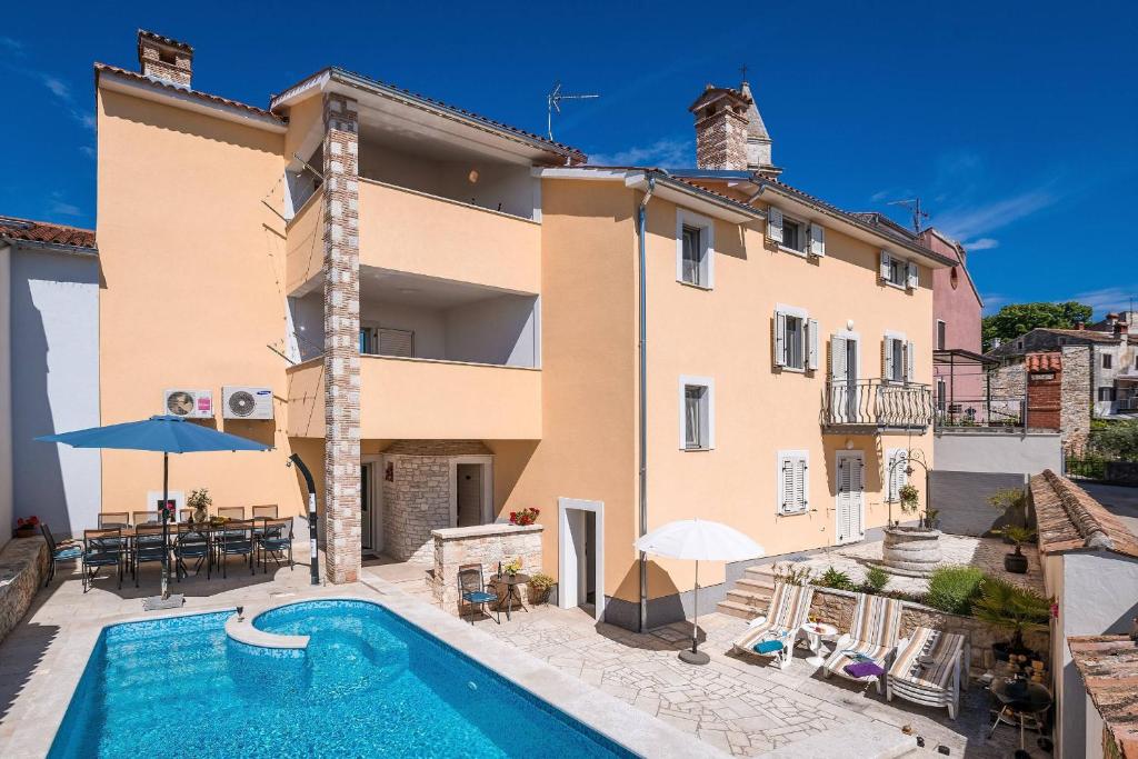 a villa with a swimming pool in front of a building at Villa Nada with 6 bedrooms in Vodnjan