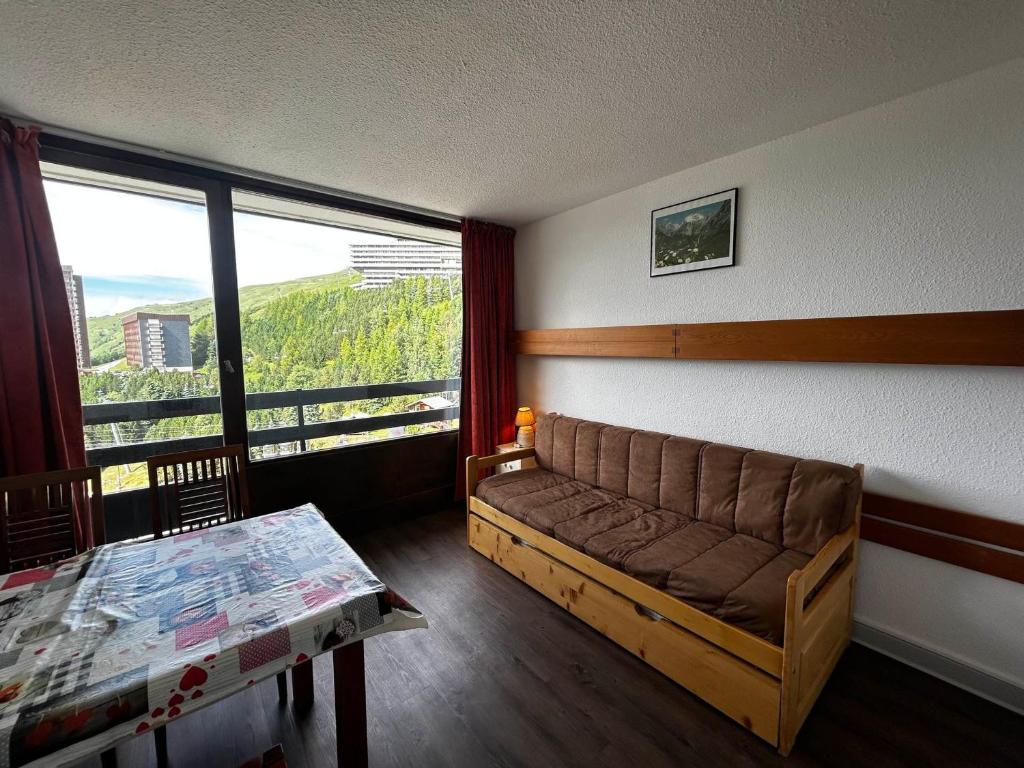 un salon avec un canapé et une table dans l'établissement Studio cosy pour 2 pers, centre des Menuires, au pied des pistes - FR-1-452-273, aux Menuires