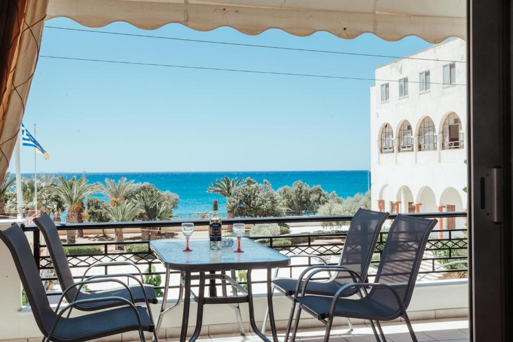 a table and chairs on a balcony with a view of the ocean at Sunny home crete in Ierapetra