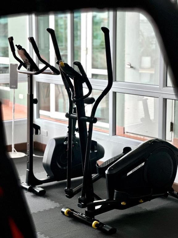 A windowed fitness room focused on upright cardio machines.