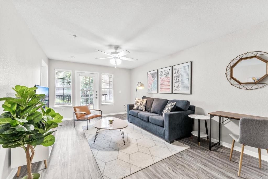 a living room with a couch and a table at Spacious 2BR King Suites w Pool, Gym, Laundry - Close to Downtown in Austin