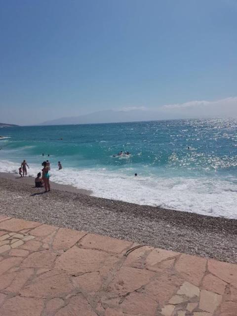 a group of people playing in the water at the beach at Blue Horizon Apartment in Sarandë