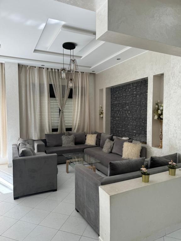 a large living room with couches and a table at Iberia in Tangier