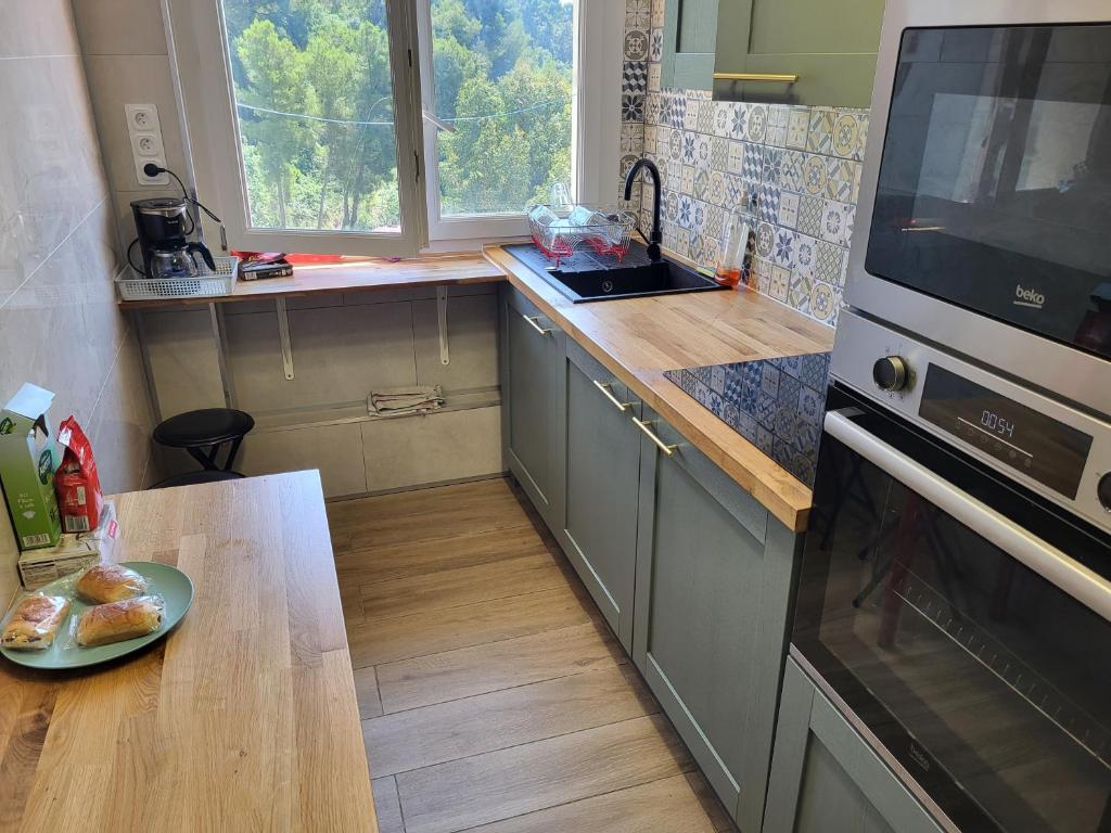 une cuisine avec une plaque de cuisson sur un comptoir dans l'établissement Private Room-1 in HANNANA Apartment- 2 min walk To Tram 12 min to Nice train station 15 min to Massena Place, à Nice