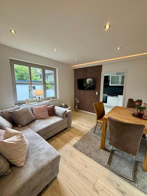 a living room with a couch and a table at Balance Apartments by M&A - Family Apartment Ferienhaus Dohrenbach in Witzenhausen
