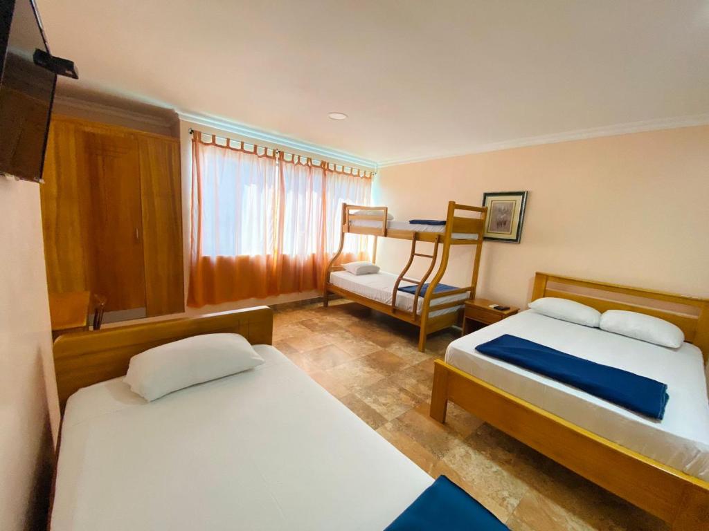 Postel nebo postele na pokoji v ubytování HOTEL MARLUZ