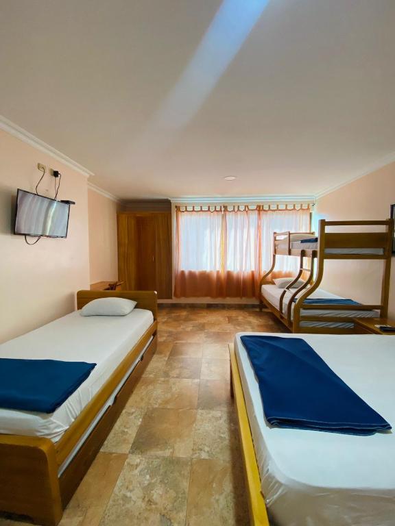 Postel nebo postele na pokoji v ubytování HOTEL MARLUZ