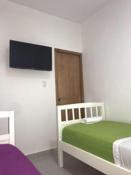 Voodi või voodid majutusasutuse Hostal Lumar toas