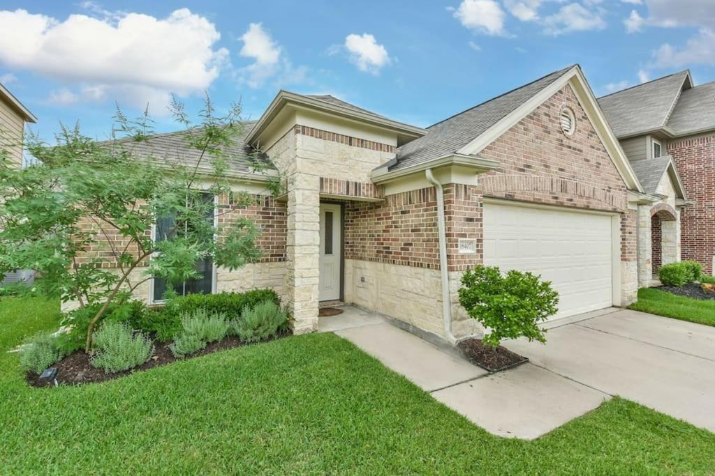 a brick house with a white garage at Early Green Home Sleeps 6 Yard King Suite in Houston