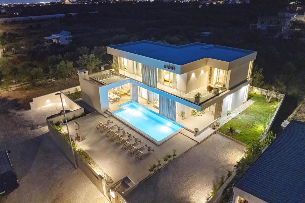 an aerial view of a house with a swimming pool at Villa La Casa in Bibinje