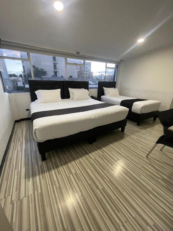 Postel nebo postele na pokoji v ubytování Hotel AMBAR KING