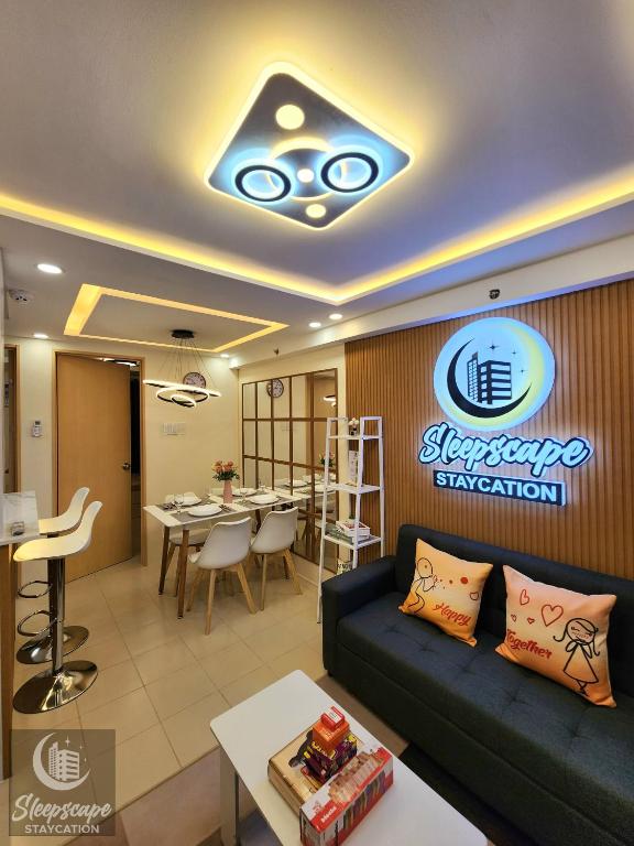 a living room with a couch and a dining room at SleepScape Staycation in Manila