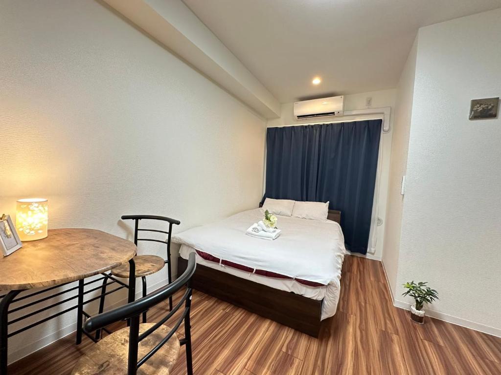 Giường trong phòng chung tại SOLASIA residence 北上野501