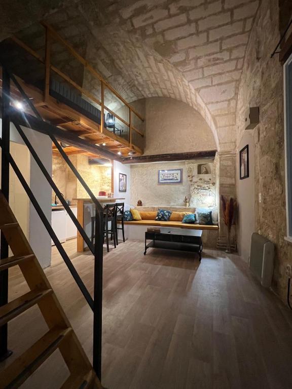 Cette chambre dispose d'une mezzanine avec un canapé et une table. dans l'établissement Centre historique quartier piéton, à Montpellier