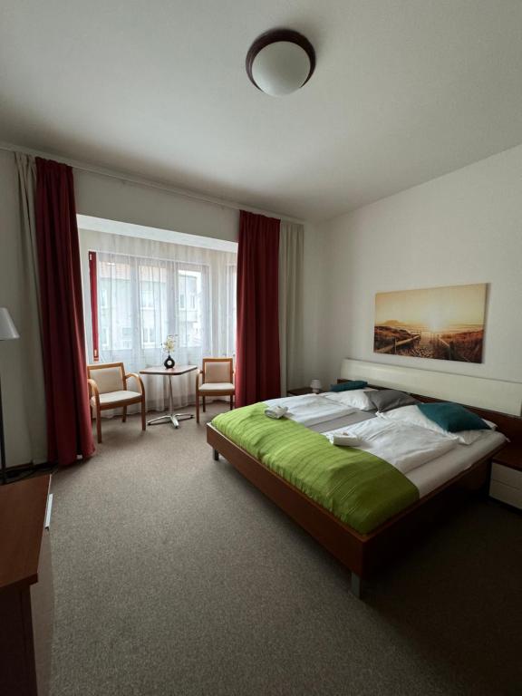 Postel nebo postele na pokoji v ubytování Pivovarský Hotel