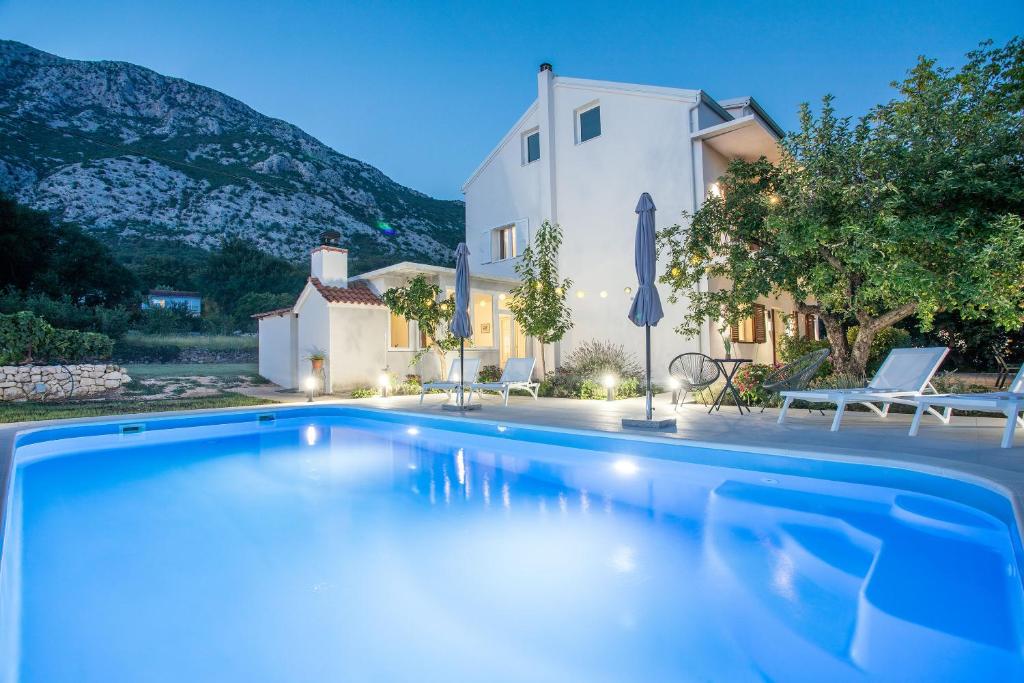 a large swimming pool in front of a house at Villa Knez in Gata