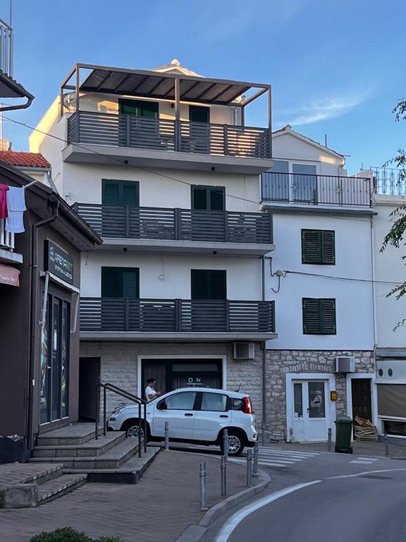 a white car parked in front of a building at Max in Vodice