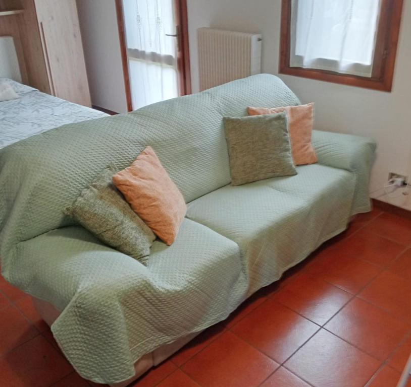 a green couch with pillows on it in a room at Residenza Diana in Vicenza
