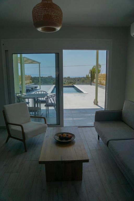 a living room with a couch and a table at MENTOROS VILLAS in Karavádhos