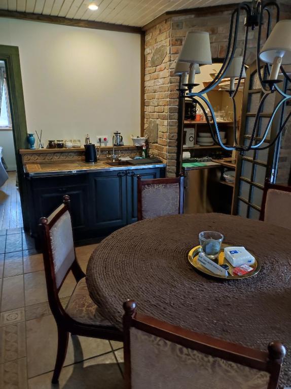 a kitchen with a table with a plate of food on it at Forest apartment in the loop of the river Neris in Verkšonys