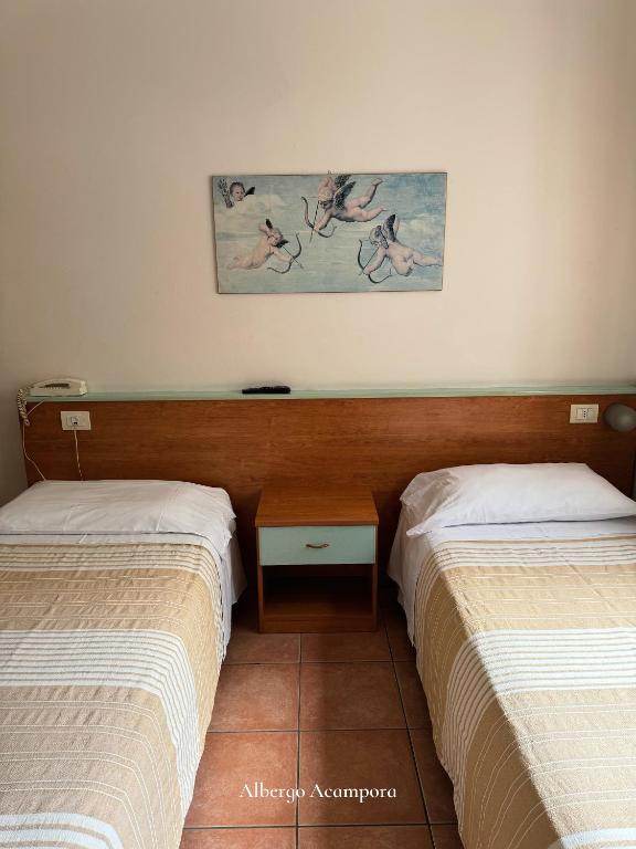 Postel nebo postele na pokoji v ubytování Albergo Acampora