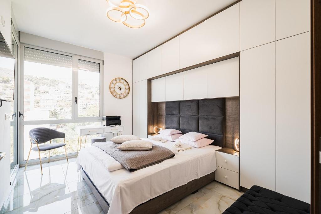a bedroom with a large bed with a large mirror at Saranda Terraces Exclusive Appartment in Sarandë