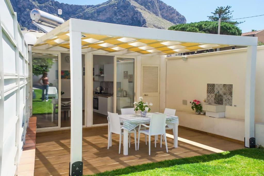 a patio with a table and chairs under a pergola at Casa vacanze Casuzza Sferracavallo Palermo in Palermo