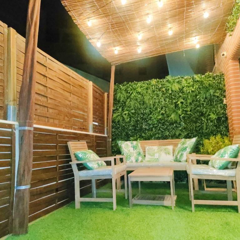 a patio with two chairs and a table at Terraza acogedora , Piscina , Parking, Airé Acondicionado in El Campello