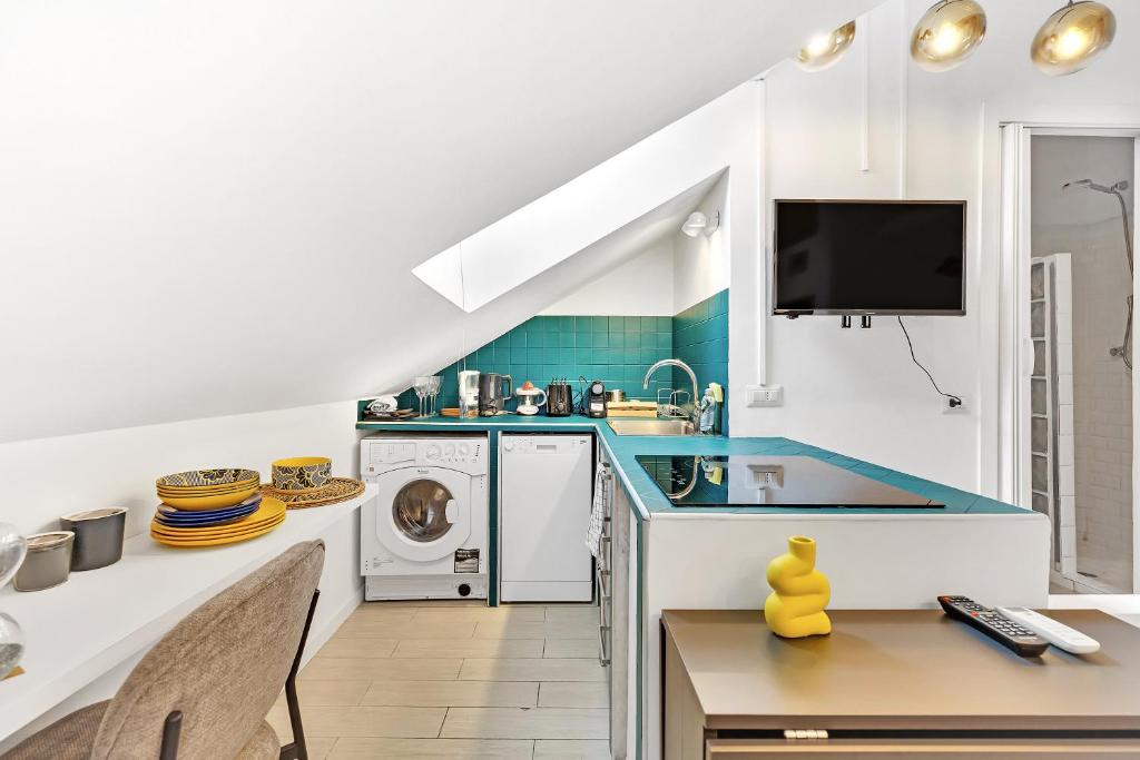 a kitchen with a sink and a dishwasher at DUOMO - Bright Gateway Downtown in Milan