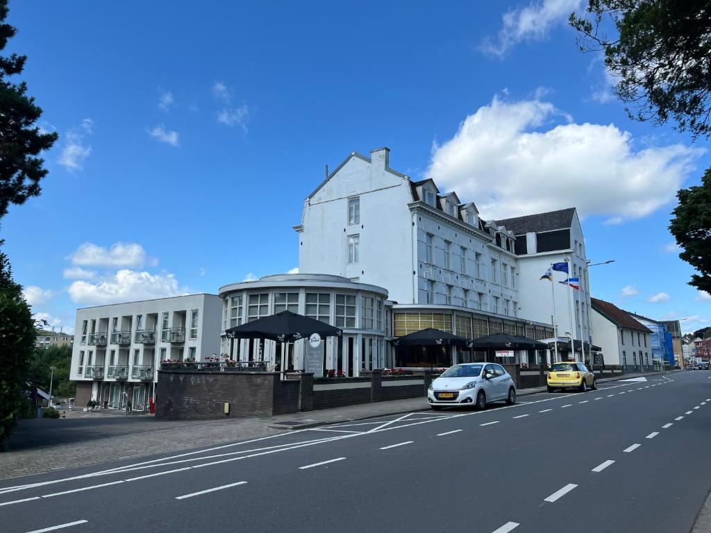 a white building on the side of a street at Hotel 2000 Valkenburg in Valkenburg