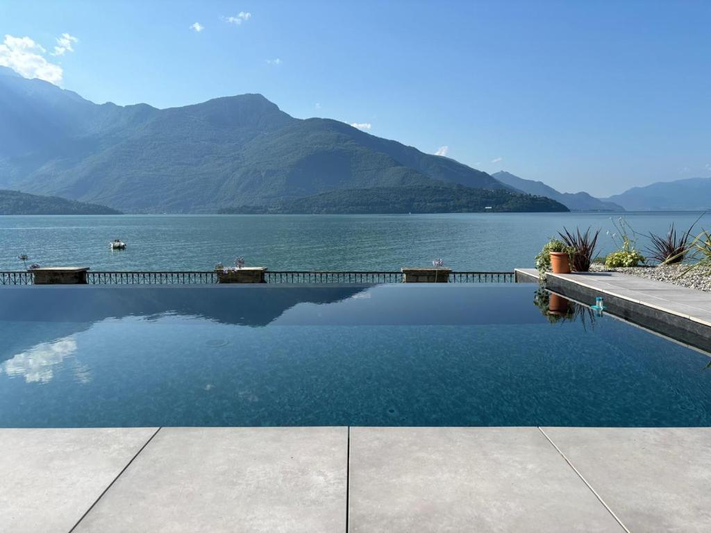a swimming pool with a view of a lake at Rosa del lago in Gravedona
