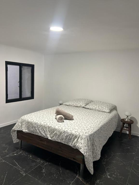 a bedroom with a bed with a blanket and a window at Liberte 2 in Marseille