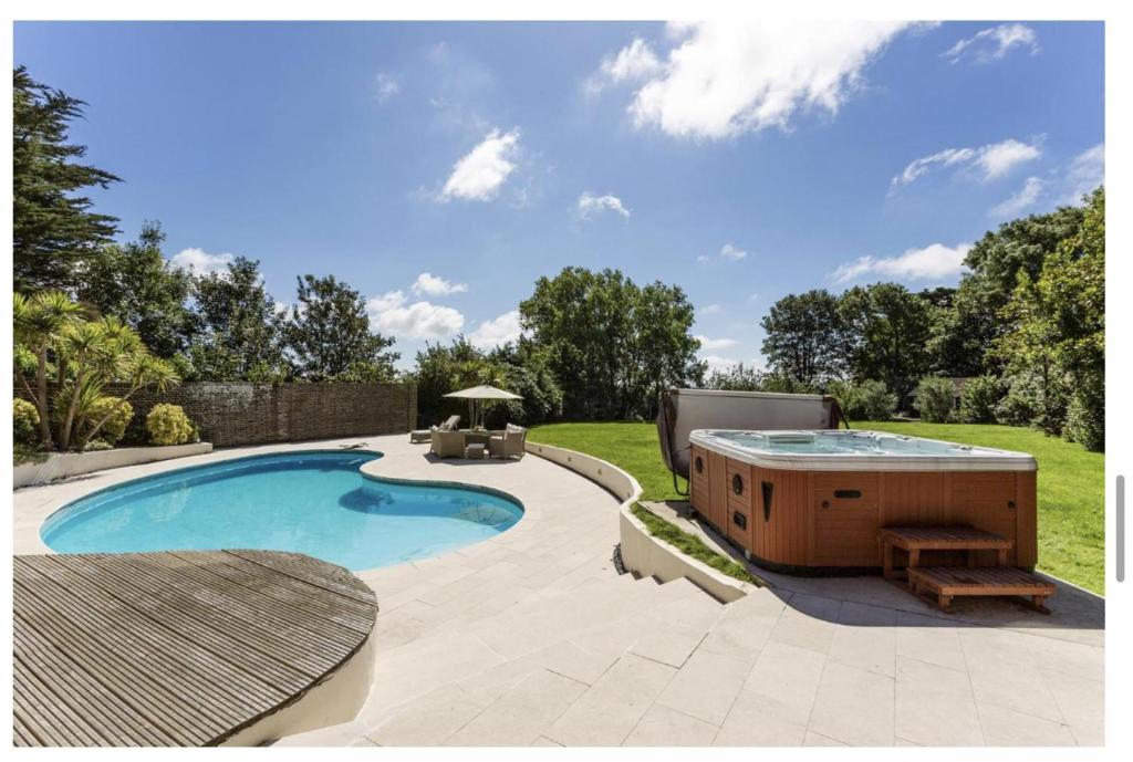 a swimming pool with a hot tub in a yard at Sleeps10 18-Parking-Garden-Pool-HotTub-Balcony in Eastbourne