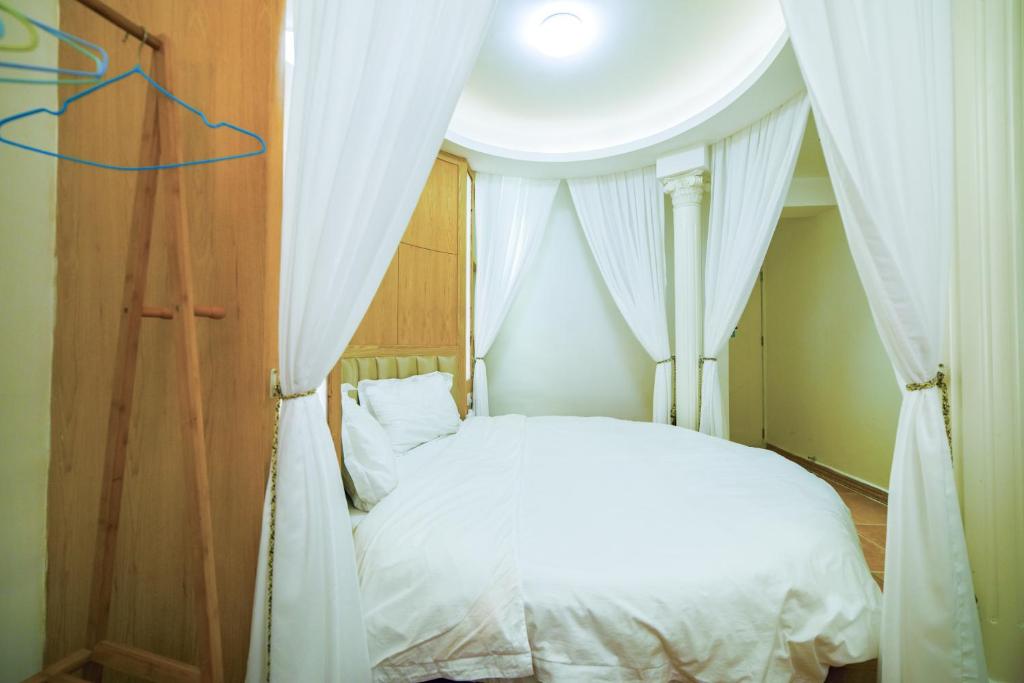 En eller flere senge i et værelse på Zhangjiajie Han Exotic Inn
