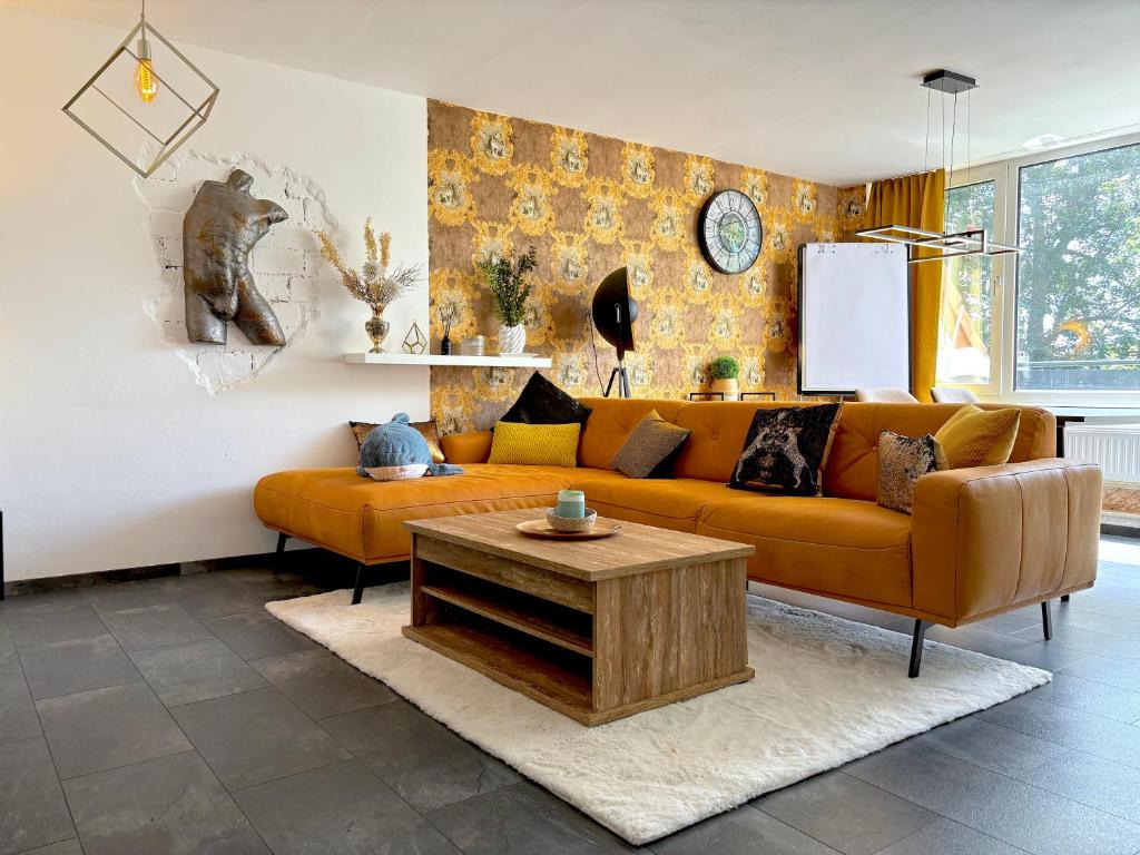a living room with a couch and a coffee table at Luxus Maisonette-Apartment - Werde zum König in der Traumwelt Beerfelde in Steinhöfel