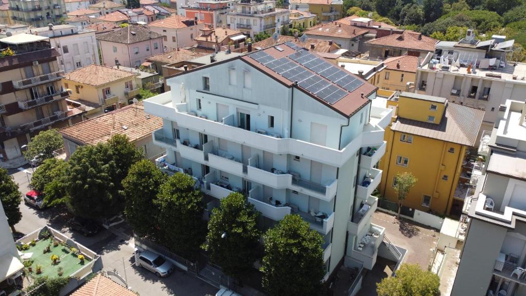 an overhead view of a white building in a city at Lugano Residence in Rimini