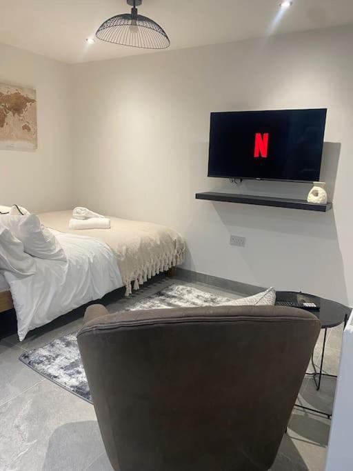a bedroom with a bed and a tv on the wall at The Courtyard - By Casa Living in Canley
