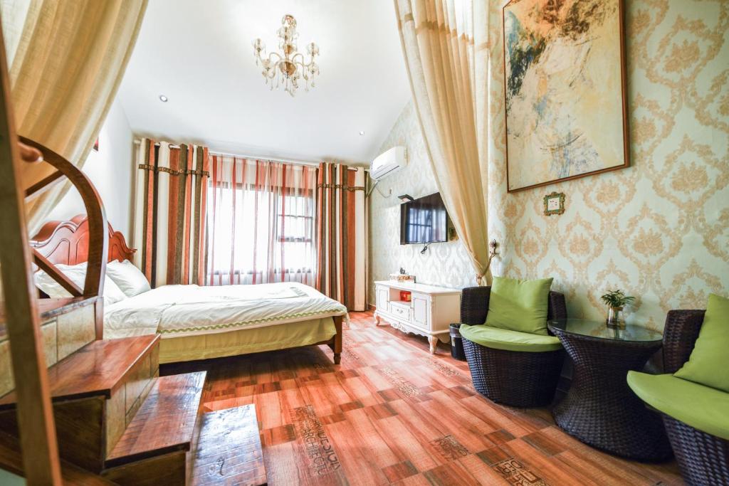 En eller flere senge i et værelse på Zhangjiajie Han Exotic Inn