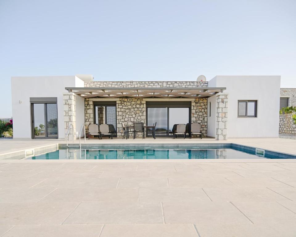 a villa with a swimming pool and a house at Villa Elaia in Sitia